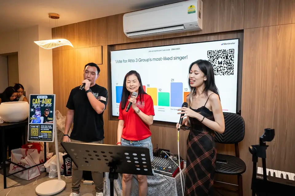 Guests using microphones and a presentation screen at a private event