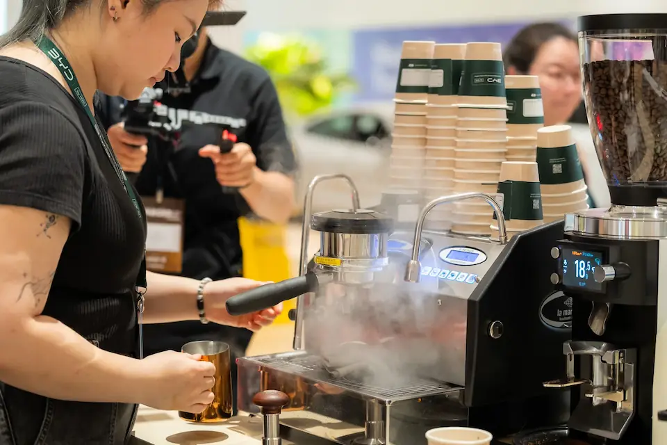 Barista preparing coffee at a SevenDaze coffee cart